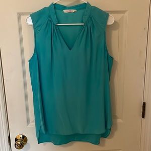 Turquoise blue silk blouse.